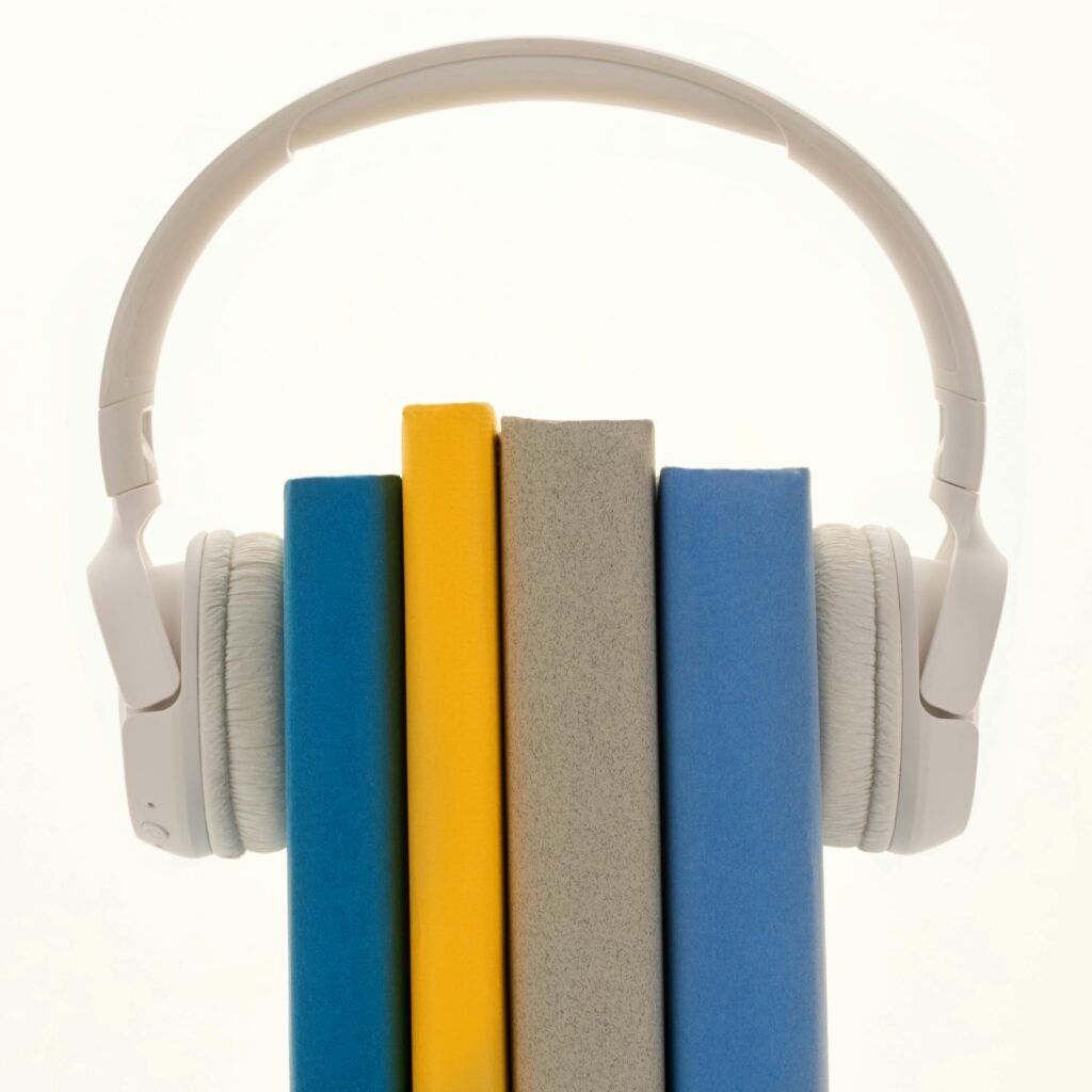pexels-photo-3394662-3394662 Creative concept of books wearing headphones, symbolizing audiobooks or learning.