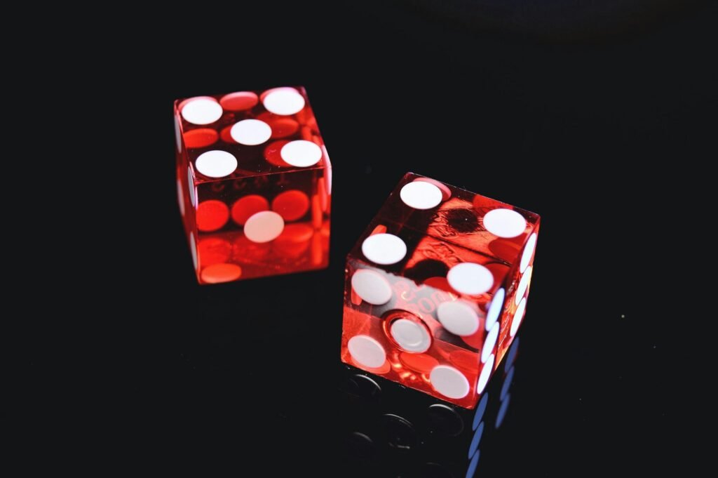 pexels-photo-965879-965879 Close-up of two red dice on black surface, symbolizing chance and luck.